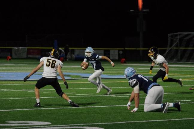 Sparta quarterback Shane Hoover on the run in the game against West Milford. Hoover threw the ball for a total of 298 yards, resulting in five touchdowns. He also kicked four points after touchdowns.