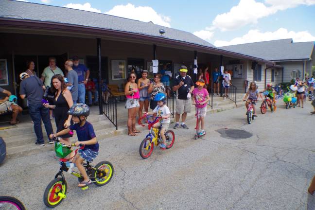 The decorated bicycle and hat parade gets underway.