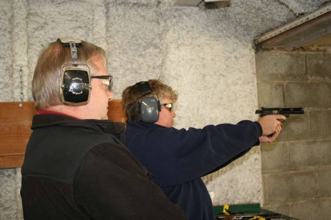 Franklin Revolver and Rifle Association hosts training Franklin Revolver and Rifle coach Bill Matthews watches as student Michelle McNeier pracitices a follow-up pause after each shot.