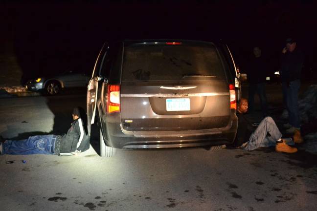 Sparta police nab alleged thieves James Bond GangþÄù members, from left, Leevan Lawrence and Jerry Montgomery sit handcuffed on Radcliff Drive after they were removed from the their vehicle at gunpoint by Sparta Police after they committed a burglary on Greenfield Hill. (Photo courtesy of the Sparta Township Police Department)