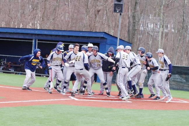 Teammates gather around as Jefferson's Kyle Haller completes game-tying homerun