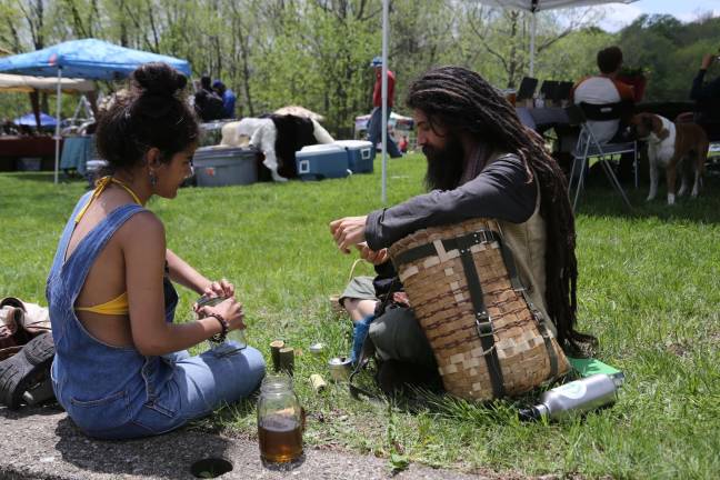 Medicine Wheel celebrated at Lusscroft Farm Laura Arias and Dan Farella make an herbal tea and use hand made bamboo cups for sampleing.