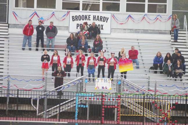 Fans of Pope John field hockey player Jordan Gulick spell out their support.