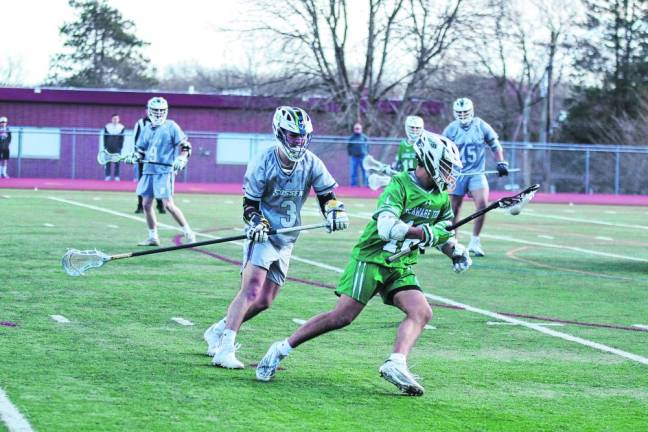 Delaware Tech's Ethan Parker advances the ball while pursued by Sussex County's Terry Terzakis (3).