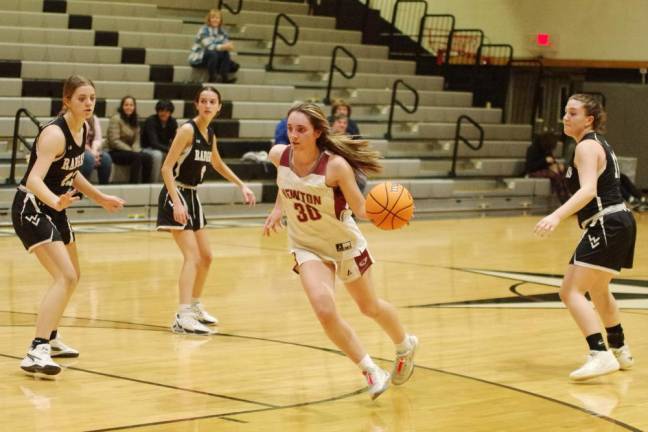 Newton's Caitlyn Pokrywa handles the ball on the court in the second half.