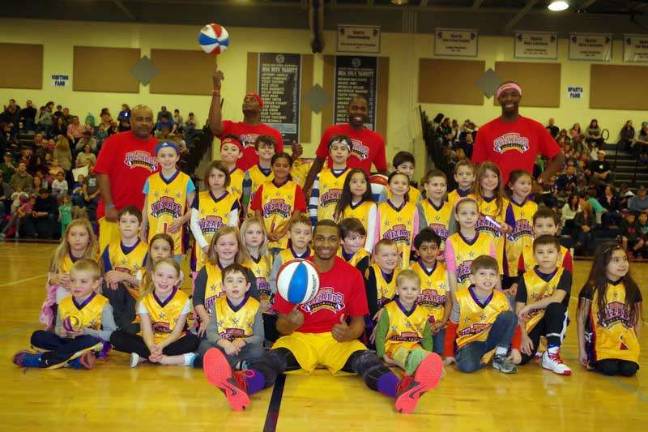 Harlem Wizards dazzle locals on the court The Harlem Wizards pose with some young fans.