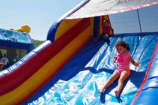 Children slide down an inflatable slide at Jefferson Township Day