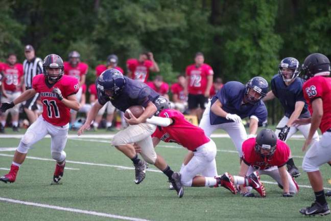 A Jefferson Falcons ball carrier breaks through the Boonton Bombers defense during a scrimmage on Friday August 19.