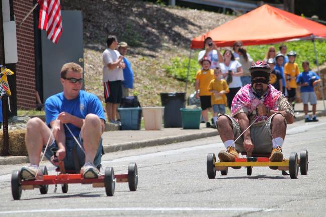 Cub Scout pack hosts annual mobile derby Akela's Cliff "Surferman" Graham and the Masked Avenger (Carlos Soares) take on the challenge.