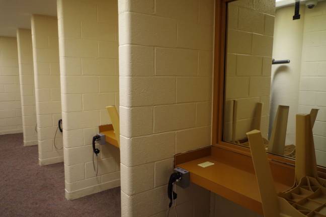 The visitation booths where prisoners and guests speak to each other with telephone handsets.