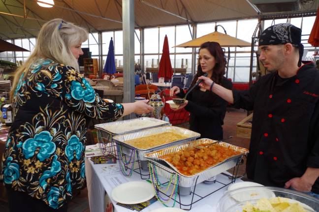 At left, Cindi Auberger of Vernon tried a combination of meatballs and shrimp with rice courtesy of Wantage's Celine's Bistro.