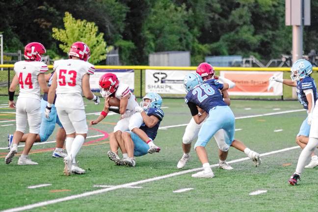 Football roundup: Vernon shuts out Dover <b>A Lakeland ball carrier is taken down by a Sparta tackler.</b>