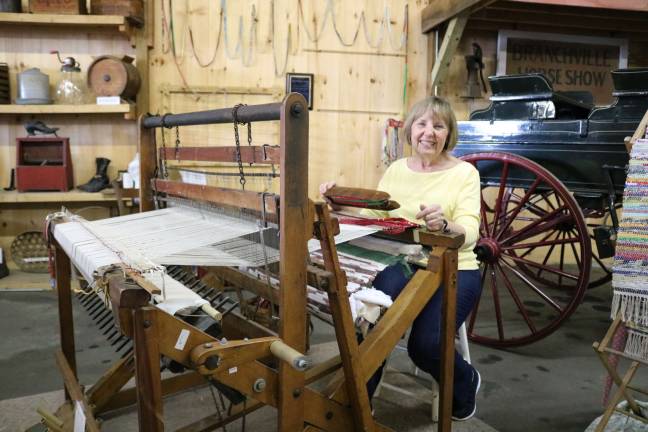 Laura Camp of the Lafayette Preservation Committee demonstrates how to weave on a 100-year-old loom.