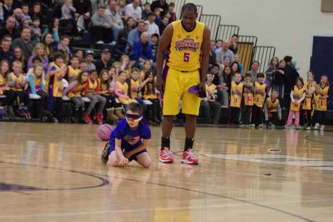 Harlem Wizards dazzle locals on the court Silliness ensues as a young fan participates in one of the Harlem Wizards antics.