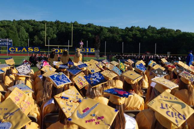 Students add a personal touch to their caps.