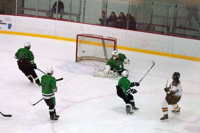 At far right Sparta-Jefferson's Matt Redding watches the puck he struck zip past Kinnelon's goalkeeper and hit the net resulting in a goal in the third period pushing his team ahead 4-2.