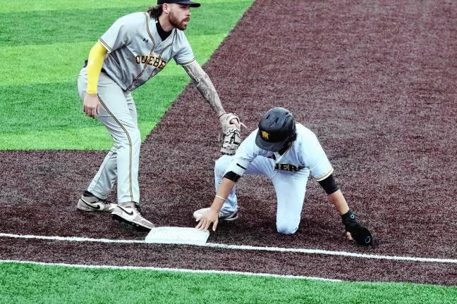 Miners leading division <b>In the third inning, Miners runner Hunter D'Amato reaches first base before the tag by Quebec's Jarrod Belbin during a pickoff attempt.</b>