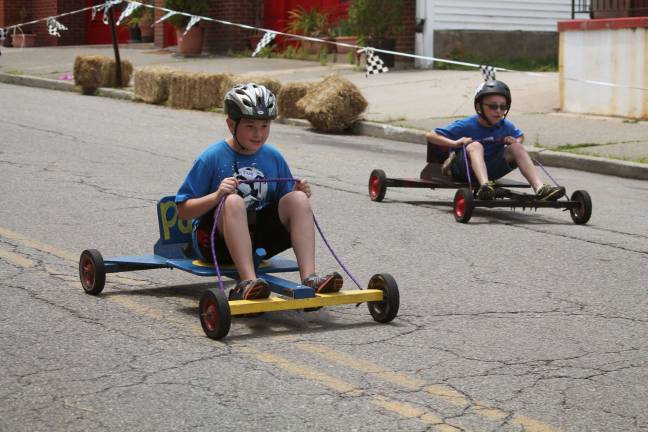 Cub Scout pack hosts annual mobile derby Justin Neal passes Luke Derenzo.