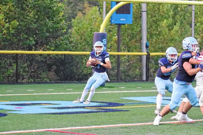 Football roundup: Vernon shuts out Dover <b>Sparta quarterback Shane Hoover is about to throw while his teammates hold back the opposition. He passed for 297 yards and four touchdowns.</b>
