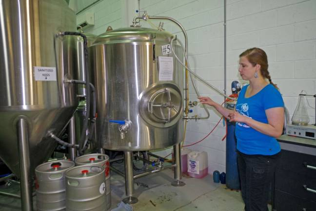 Brewery owner Heide Hassing is shown giving a tour of the brewery. It takes three to six weeks before the beer is ready and some of it is aged in wooden bourbon casks.