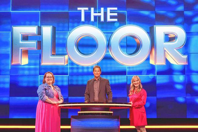 Competing on ‘The Floor’ Jeorgi Smith, right, competes on season three of ‘The Floor,’ a game show hosted by Rob Lowe, center, on Fox. (Photos provided)