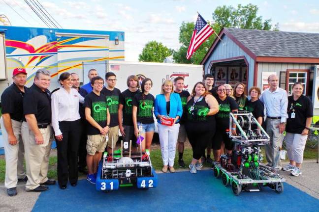 Lieutenant Governor of New Jersey, Kim Guadagno (center) poses with the Newton High School robotics team and other guests. Lieutenant Governor of New Jersey, Kim Guadagno met with the Newton High School robotics team at the Sussex County Fair on Monday, August 8th 2016. Ms Guadagno interacted with the team members as they spoke with her about science and engineering and demonstrated several machines built by the team.