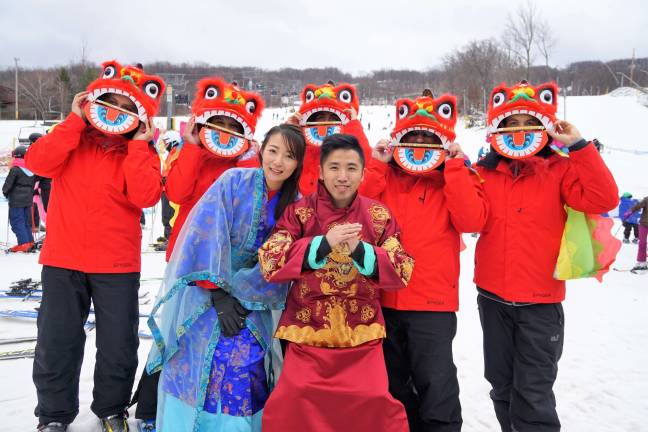 Wendy and Jordan, front row from left, and Chinese dancing lions, back row, all celebrate Chinese New Year at Mountain Creek.