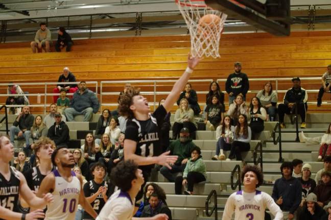 WV1 Wallkill Valley's Chris Bila leaps high during a shot in the second half of a game against Warwick Valley of Orange County, N.Y., on Friday, Dec. 29. Warwick Valley won, 58-42. (Photos by George Leroy Hunter)