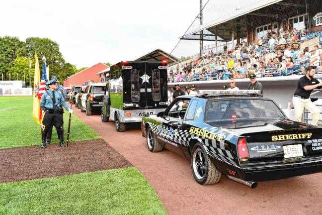 Photos: Battle of the Badges III <b>Law enforcement vehicles drive past the grandstand.</b>
