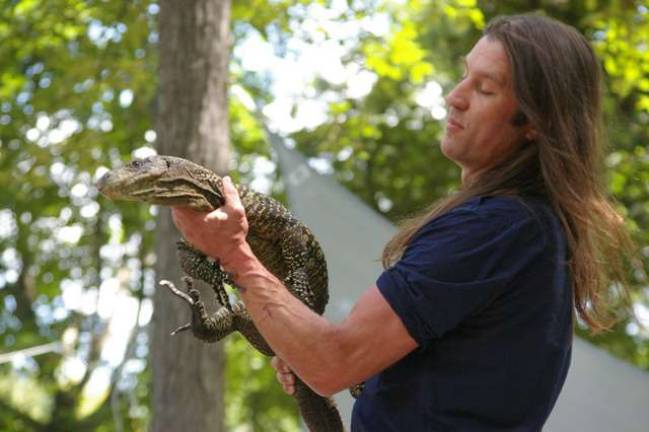 Urban Tarzan is shown with a crocodile monitor, which is native to New Guinea. These lizards grow to be the world's longest and can measure up to about eight feet.