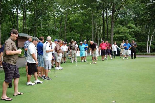 Alonso Strong Golf Outing hosts fundraiser Golfers line up to compete in the Putting Contest held at the Alonso Strong Golf Outing.