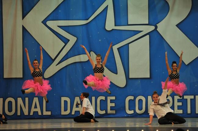 Grease dancers leap.