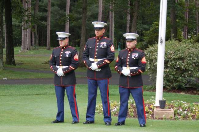 Standing at ease are Marine Sergeants Samuel Moorehead, Louis Serafin and Fernando Fuentes after raising the Flag at the Alonso Strong Golf Outing to start play.