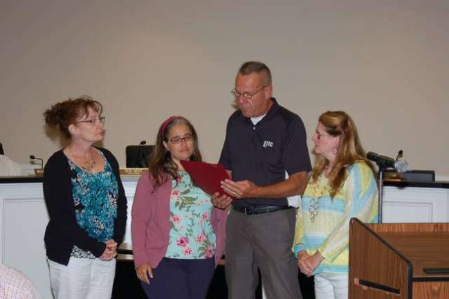 Jefferson Township Council President Richard Yocum reads a resolution from the Jefferson Township Council to Janet Boetticher and Michelle Craig, for a Mental Health Stigma Free Jefferson Township.They and Councilwoman Debi Merz are members of the &quot;Jefferson Township Connect, Jefferson's Mental Health Project&quot;.