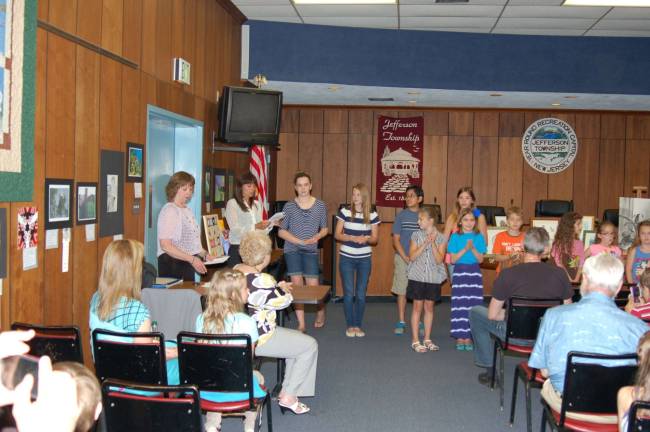 Kathleen Weir and Renee Simler, both art teachers at the Jefferson Township High School, introduce the student artists. The art work of the student artists was displayed on the walls of the Council Chamber for everyone to see.