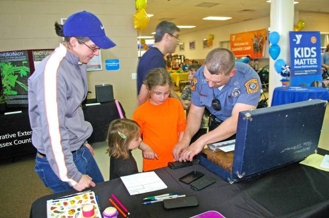Hardyston Township Police Department Patrolman Mike Petershack spent much of the day fingerprinting children during the YMCA&#xfe;&#xc4;&#xf4;s Healthy Kids Day. The fingerprint sheets were given to the parents for safekeeping in the event an emergency might arise.