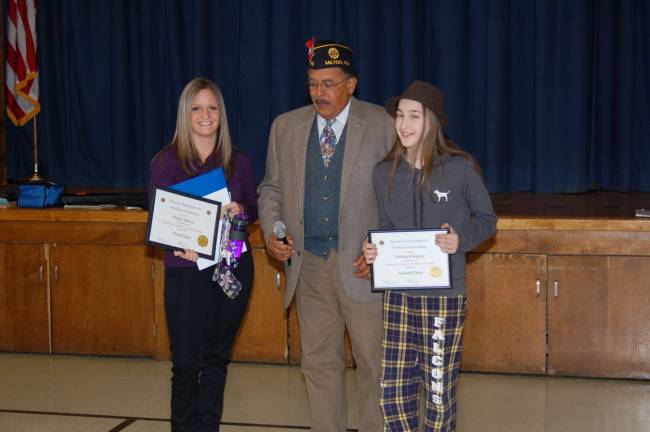 American Legion hosts coloring contest Kelly Daly, fifth-grade Teacher accepted the third-place Certificate for Patrik Jakove, Past Commander Legion Post 423 Clifford Williams and Natalia Klepacz, second-place winner.