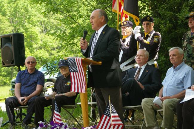 Photo by Chris Wyman Freeholder Director Rich Vohden speaks of Vernon Township Vietnam War veteran John Harrigan&#xed;s dedication to the establishment of the veteran&#xed;s cemetery. Harrigan is seated at the far right.