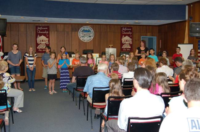Student artists from all the schools in the township are shown in the Council Chambers at the Municipal Building. They were introduced to the audience and received an ovation in appreciation for the art work they had accomplished during the school year. Middle School Art Teacher Karen Correia is in the background.