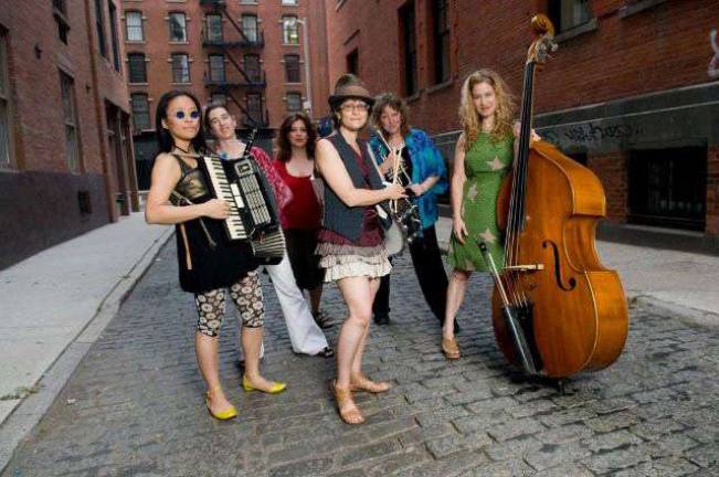 Photo by Angela Jimenez The all-woman klezmer band Isle of Klezbos is photographed in a portrait and in performance at the 92Y Tribeca in New York City.