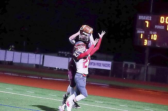 Newton defensive back Aaron Fantasia knocks away the football from the outstretched hands of High Point wide receiver Nick Douma preventing a catch in the first quarter (Photo by George Leroy Hunter)