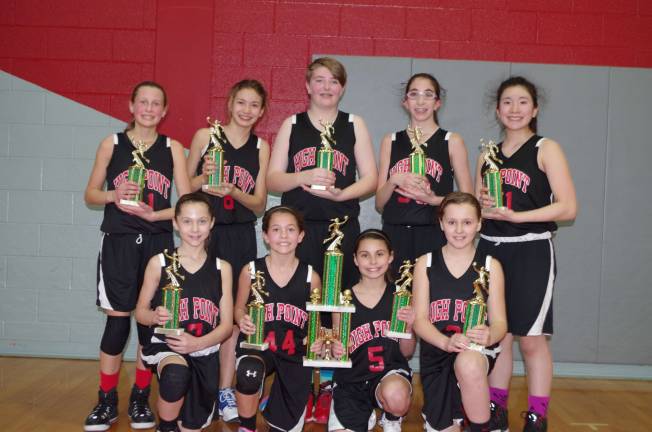 The sixth grade High Point Wildcats pose with their championship trophies.