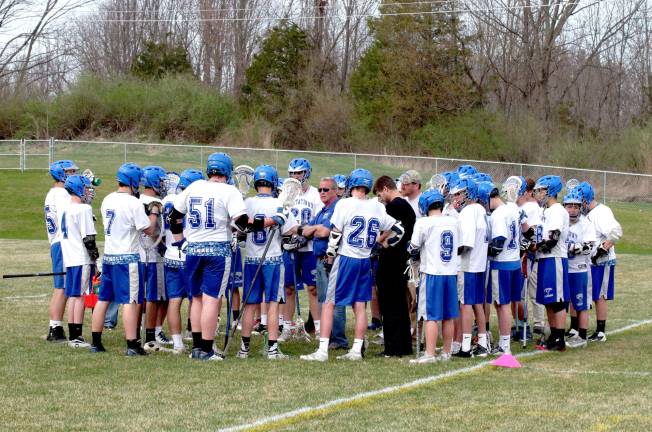 Kittatinny head varsity lacrosse coach George Morville (sunglasses) speaks with the Cougars. Kittatinny Regional High School defeated Wallkill Valley Regional High School in boys varsity lacrosse on Monday, April 28, 2014. The final score was 20-5. Kittatinny clinched the NJAC Independence Division for its first championship in program history. The game took place at Kittatinny Regional High School in Newton, New Jersey.