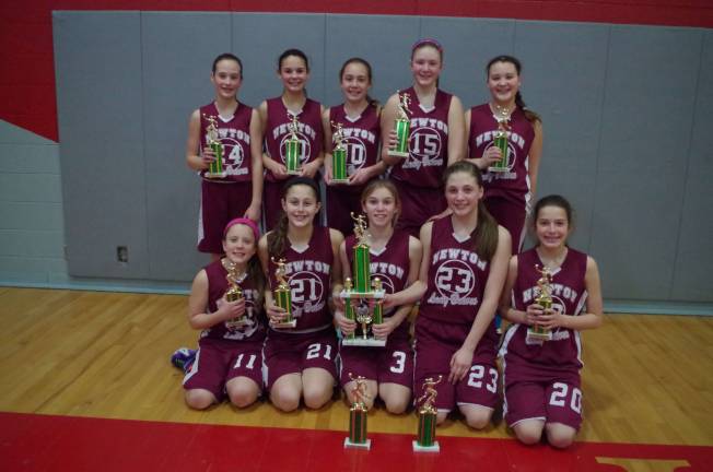 The seventh grade Newton Braves with their championship trophies.