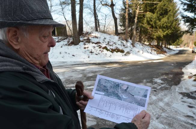 Photo by Daniel Fitzsimmons George Feighner with a plan outlining the pipeline's path through his property.