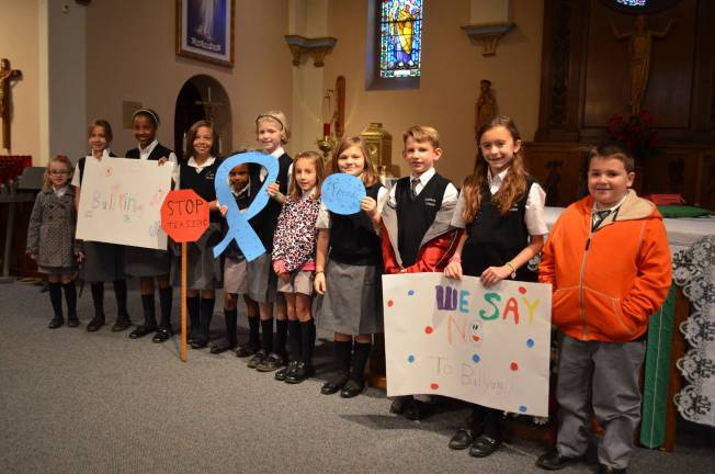 Immaculate Conception school has bully-buddies Immaculate Conception fifth-grade students hold up posters and placards in opposition to bullying.