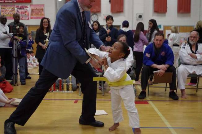 Four year old Sade Adeyeri gives a hard elbow strike to a wood board. Adeyeri represents DayHan Holistic Martial Arts of Leonia, N.J