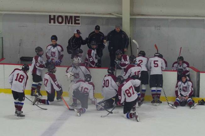 NLV coaches talk strategy with the players.