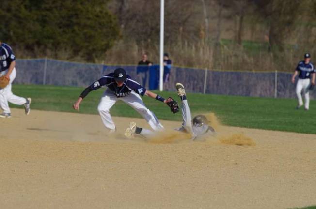 Sparta second baseman Austin Unglaub stretches to make the tag in a boy's varsity baseball game against Jefferson Township High School.