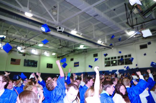 Pope John XXIII Regional High School graduates do the traditional hat toss at the conclusion of the graduation ceremony.